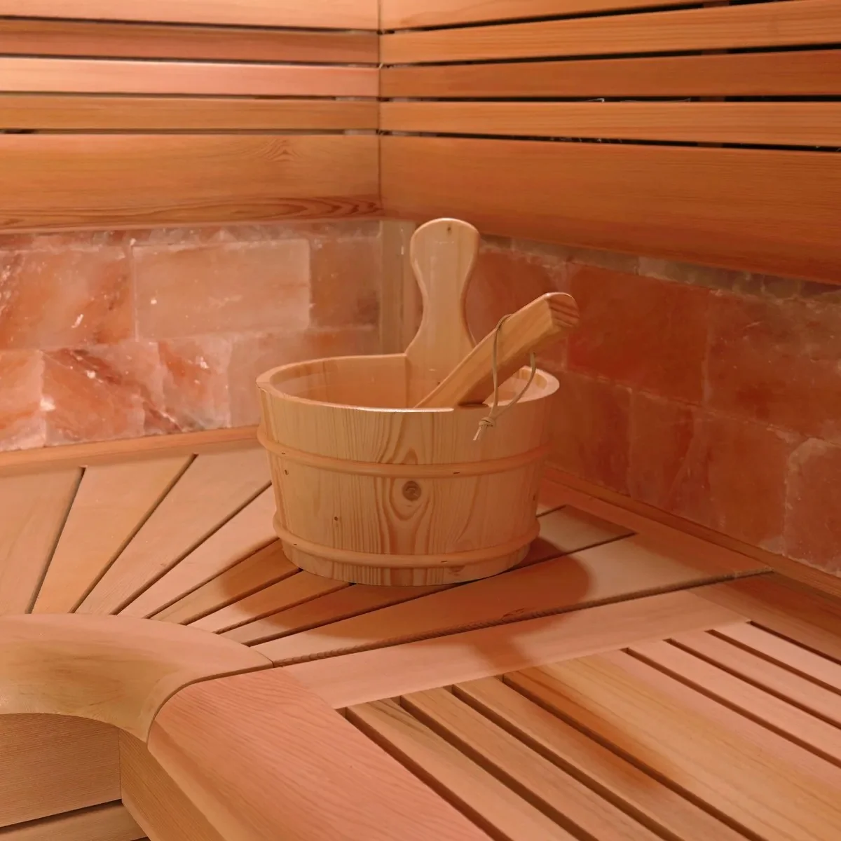 Steam & Oak Prism indoor sauna interior with timber benches and a salt stone wall